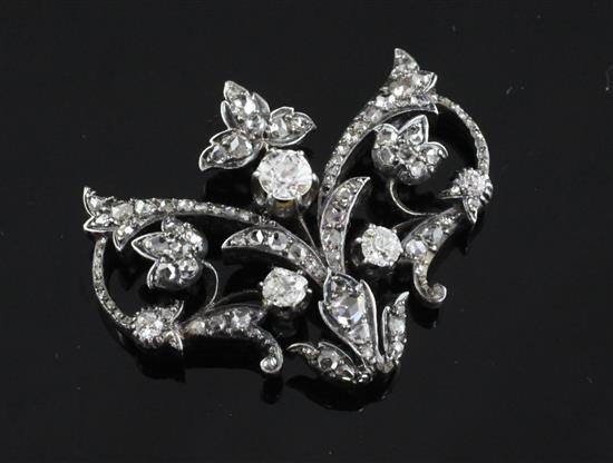 A late Victorian gold, silver and diamond open work brooch, width 1.5in.